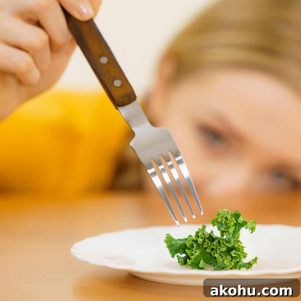What Causes Picky Eating in Kids — and How to Fix It 4 kid with fork and piece of kale