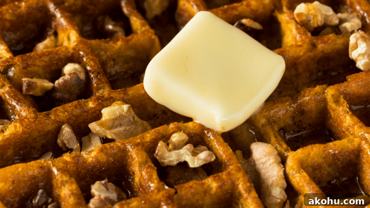 Keto Pumpkin Spice Waffles topped with butter and walnuts