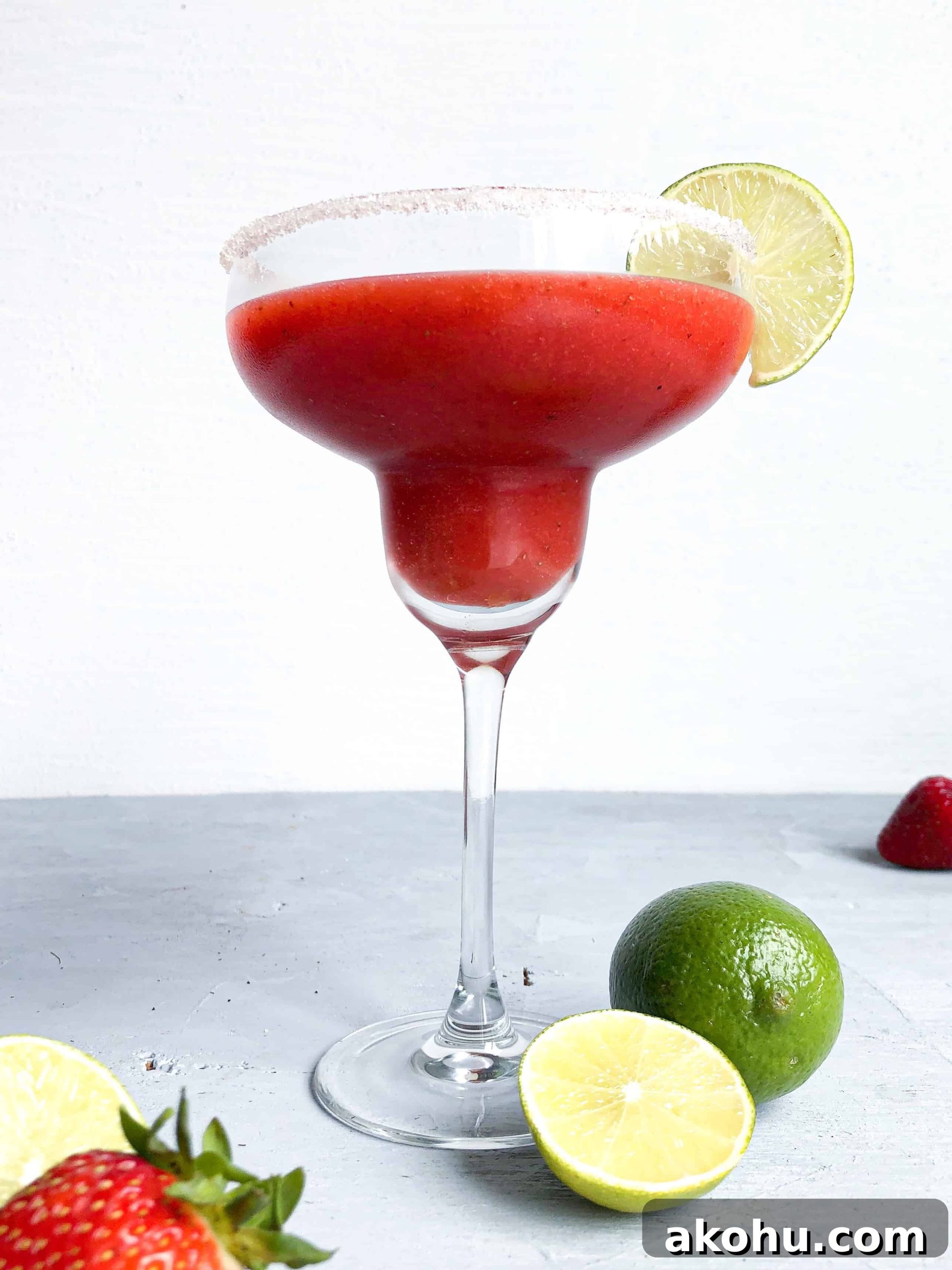 A spicy strawberry margarita with a sugared rim