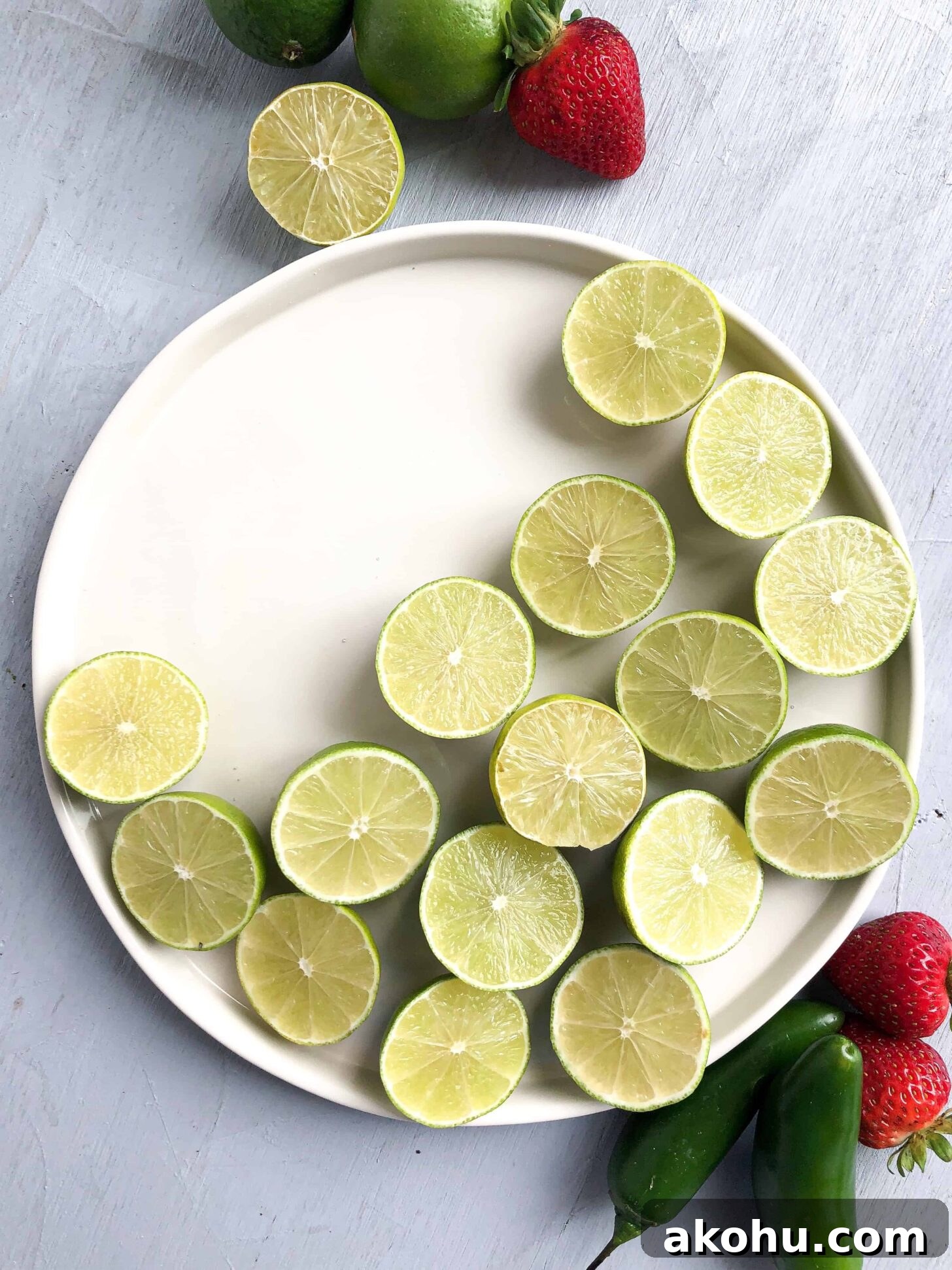 A plate of limes cut in half in a crescent shape