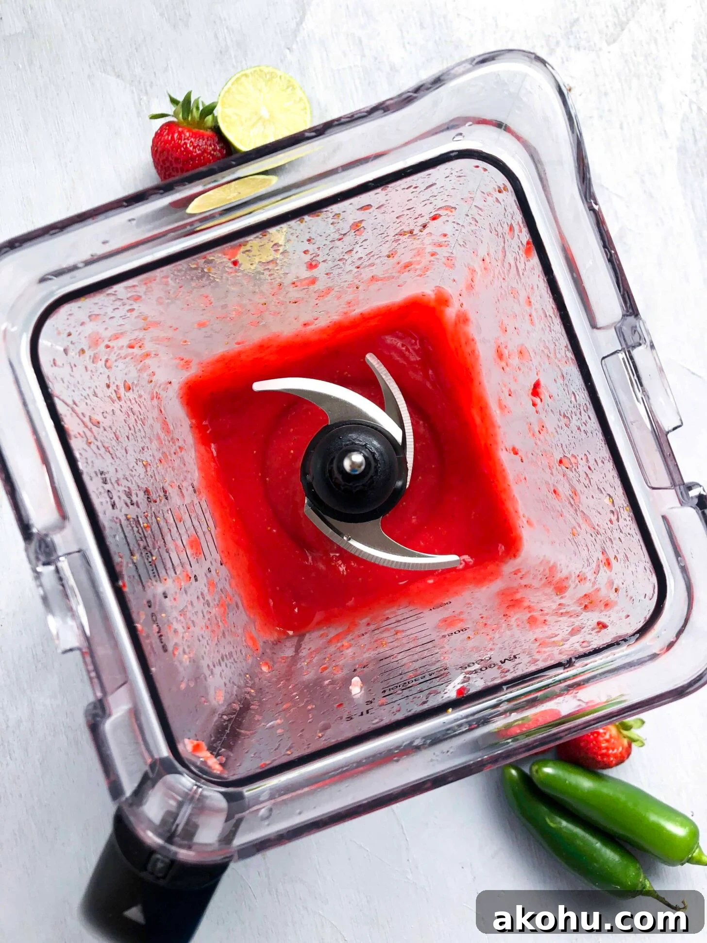 A blender full of strawberry margarita
