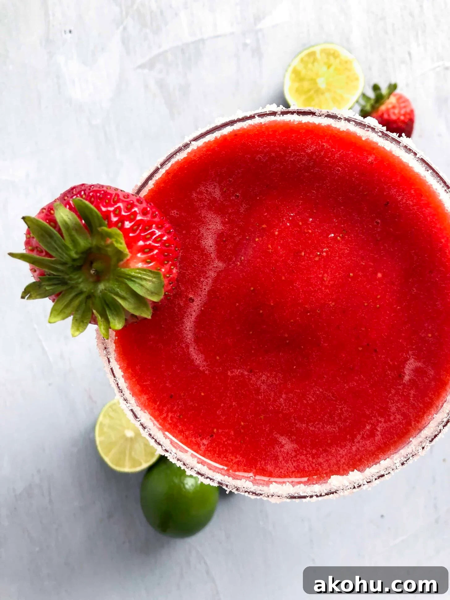 A spicy strawberry margarita with a sugared rim