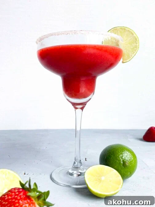 A spicy strawberry margarita with a sugared rim