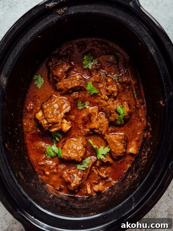Slow cooker lamb curry pictured in a slow cooker.