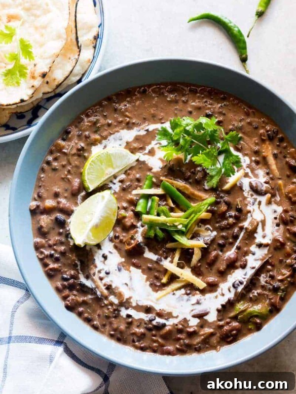 Dal Makhani topped with cream and served in a blue bowl.