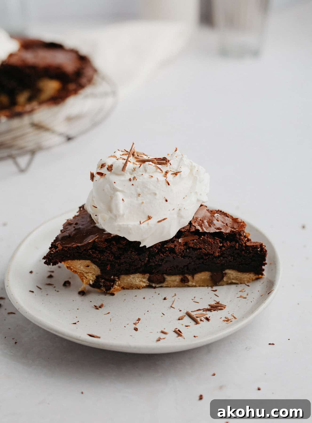A slice of brownie pie with a dollop of whipped cream