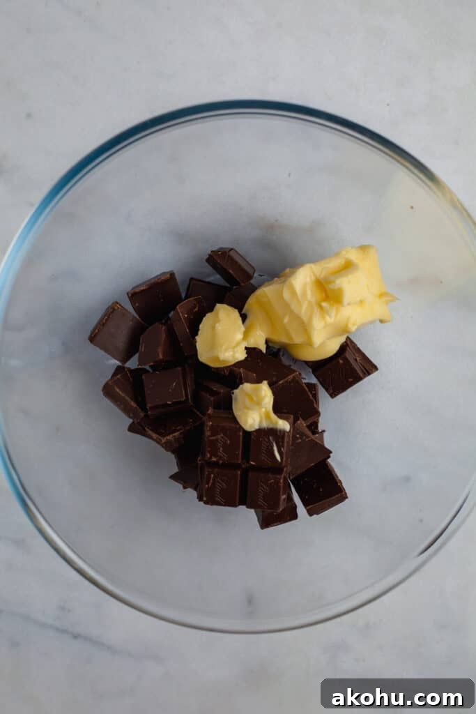 Glass bowl with chopped chocolate and butter