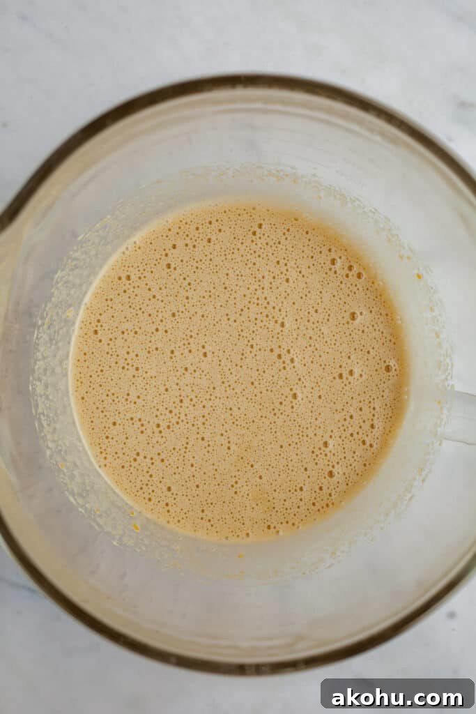 Whipped eggs and sugar in a glass bowl