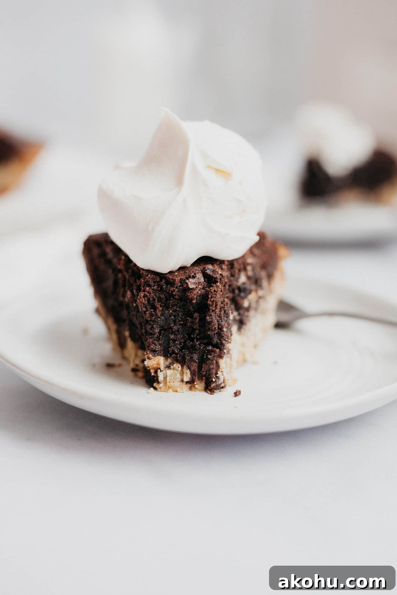 straight on view of a slice of brookie pie with a bite taken out of it