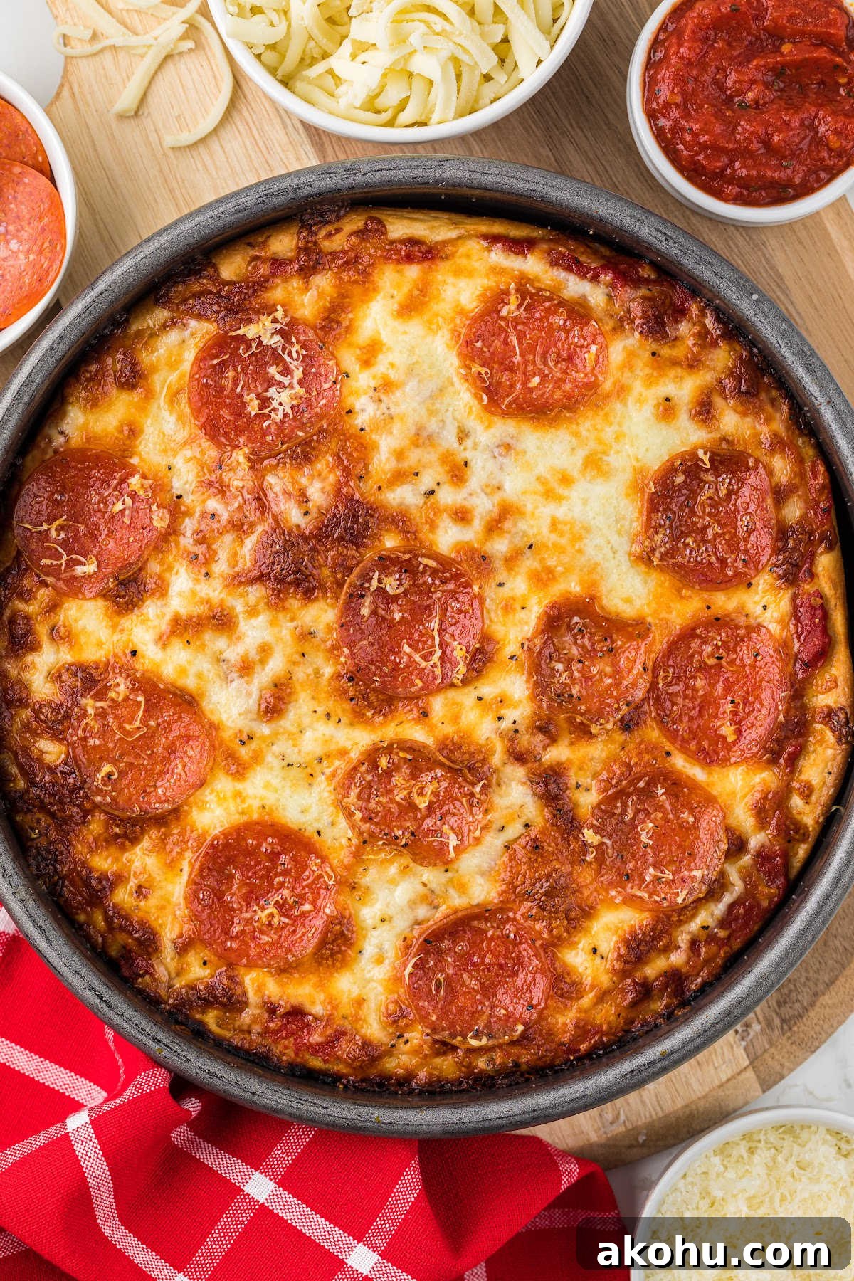 top view of deep dish pizza with pepperoni in pan.