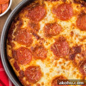 close up of baked deep dish pizza in pan, with pepperoni on top.