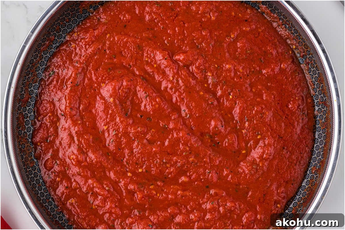 pizza sauce in skillet.