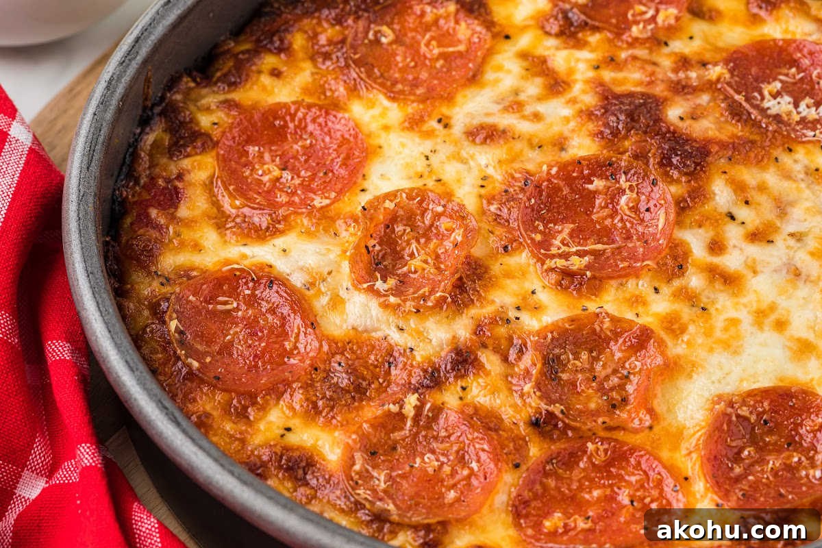 close up of baked pepperoni pizza in pan.