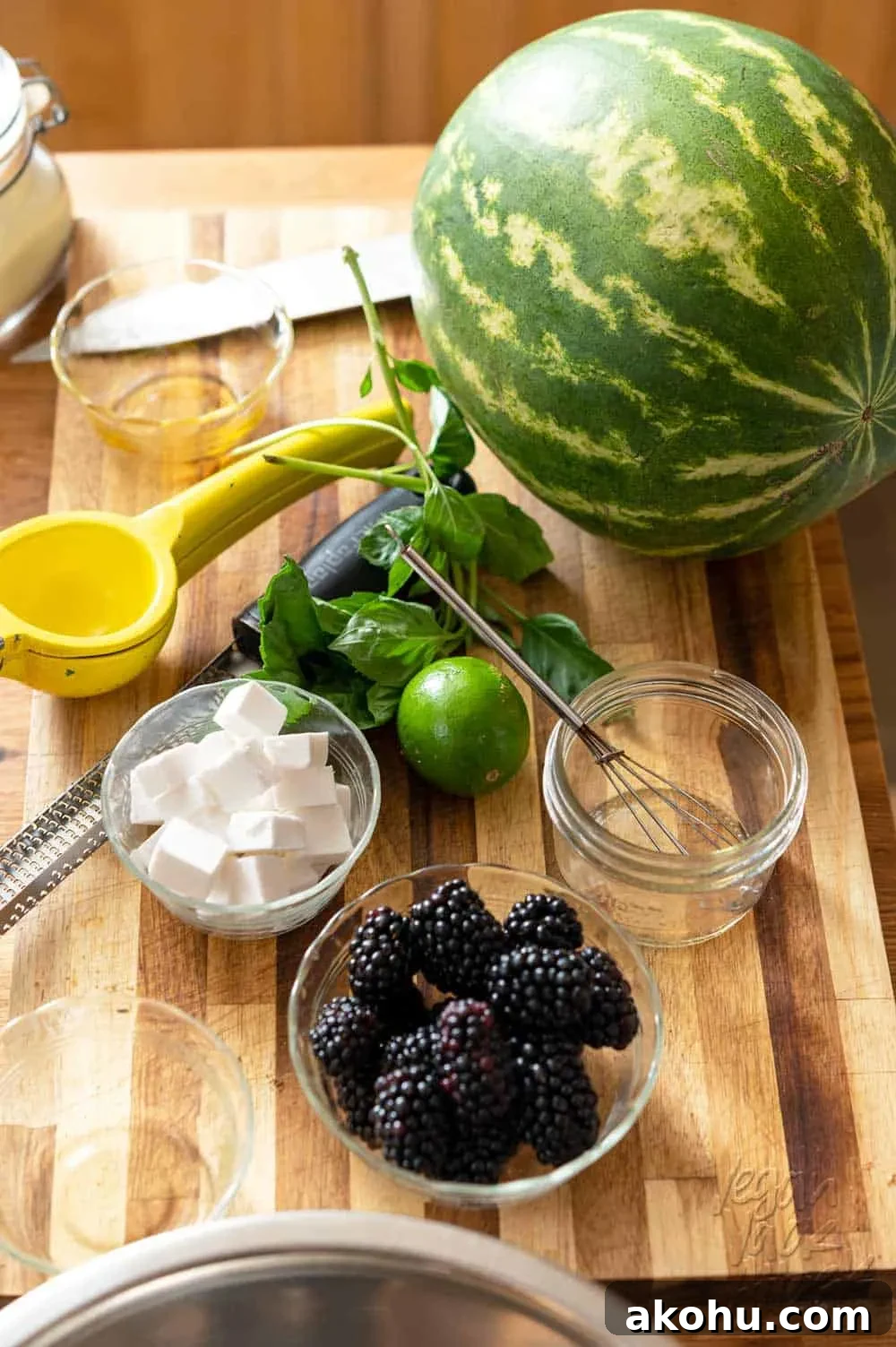 Watermelon, blackberries, vegan feta, lime, and basil on a cutting board