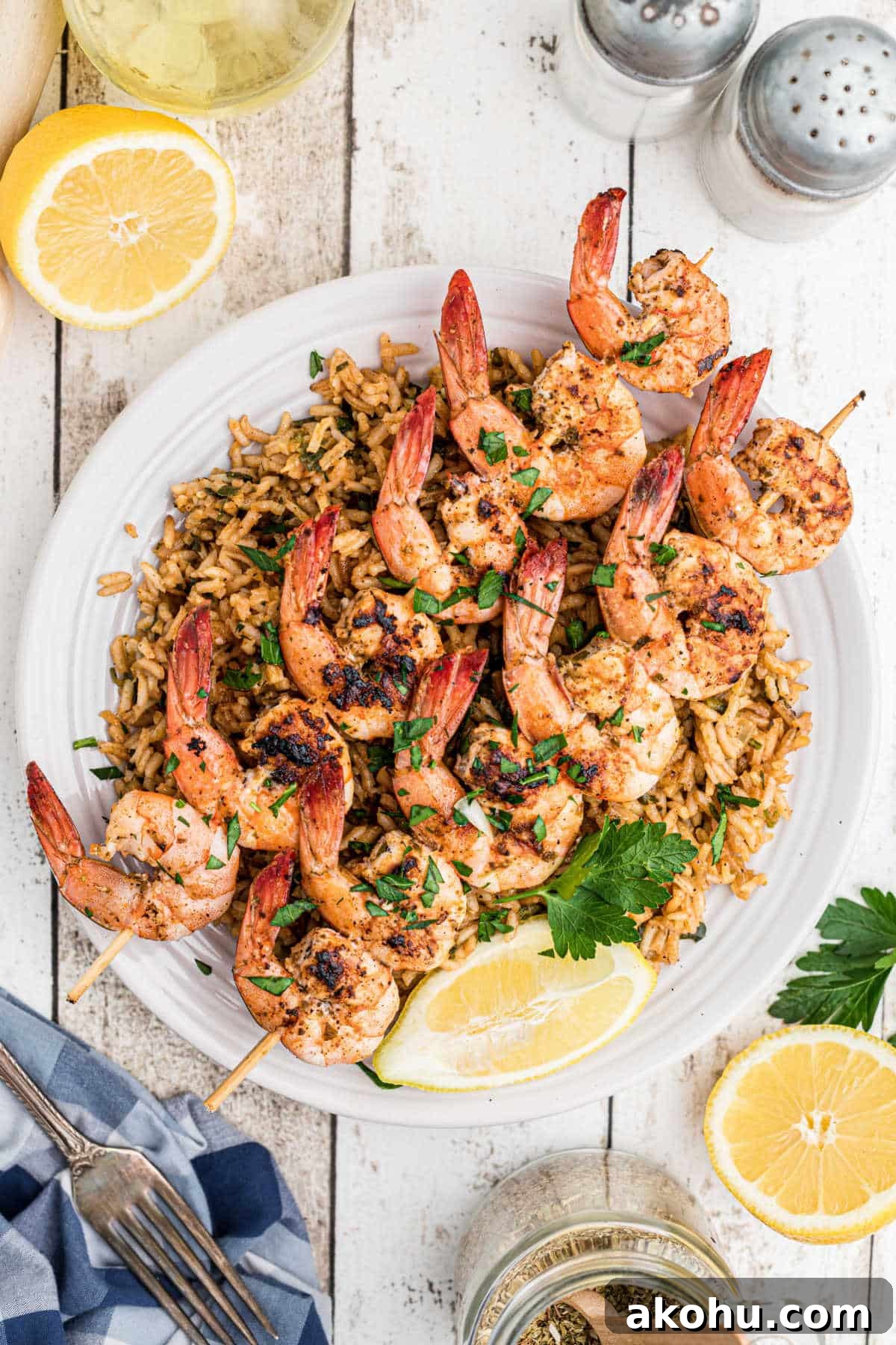 Texas Roadhouse-Style Garlic Grilled Shrimp Recipe 2 skewers of texas roadhouse grilled shrimp on top of seasoned rice