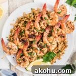 Texas Roadhouse-Style Garlic Grilled Shrimp Recipe 7 overhead shot of some texas roadhouse grilled shrimp on skewers on top of seasoned rice