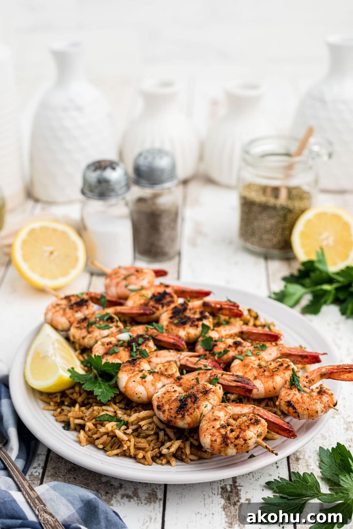 Texas Roadhouse-Style Garlic Grilled Shrimp Recipe 6 texas roadhouse grilled shrimp skewers on top of seasoned rice with lemons in the background