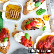 Tomato Confit & Burrata Crostini with a spicy sweet drizzle of chili honey