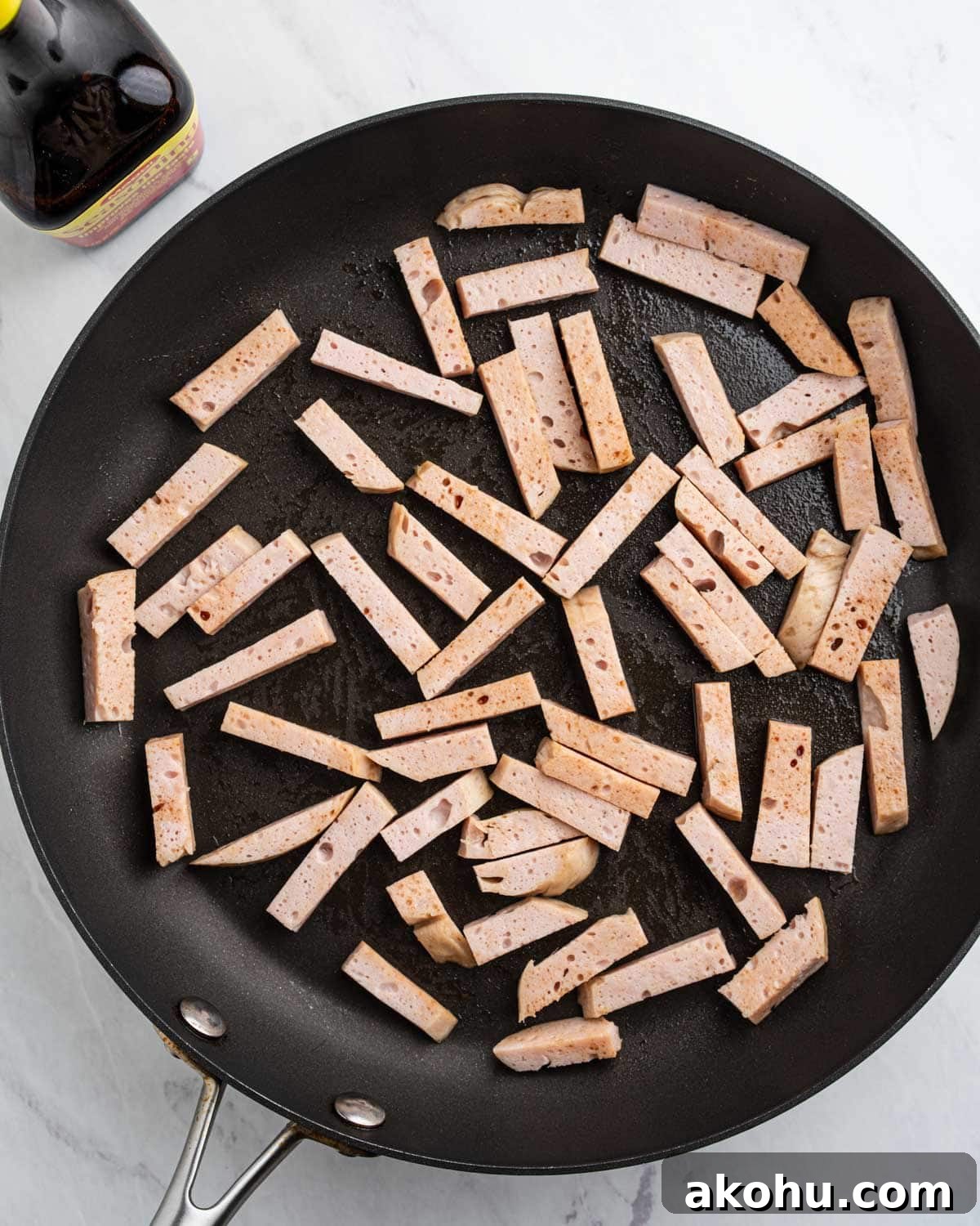 sliced pork loaf in pan with soy sauce.
