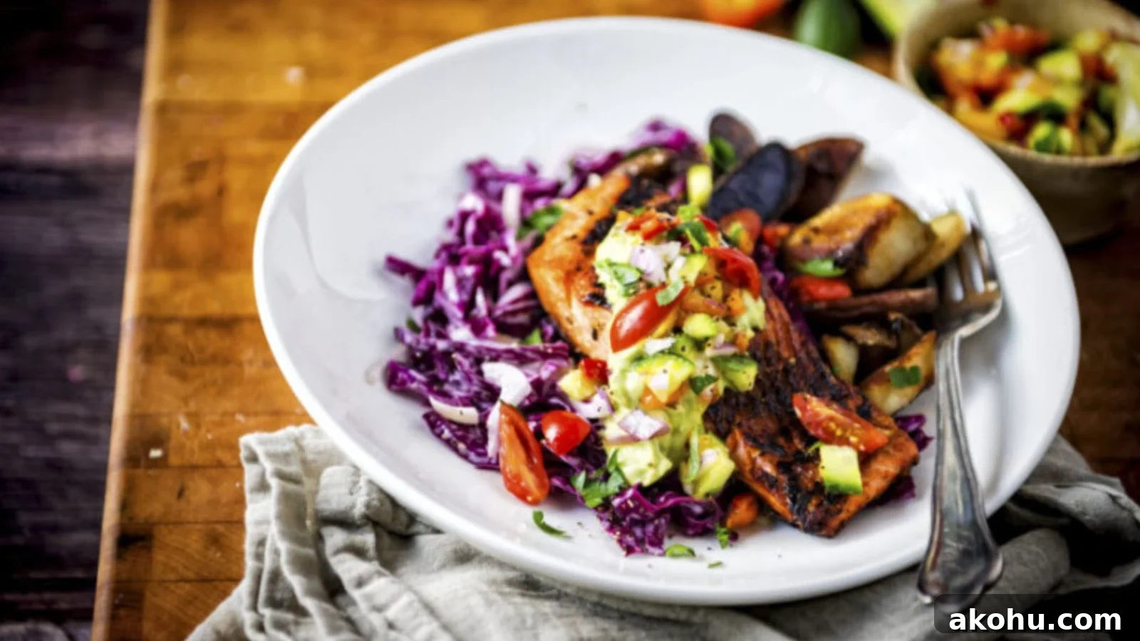 Salmon blackened in cast iron with dark charred crust and flaky interior.