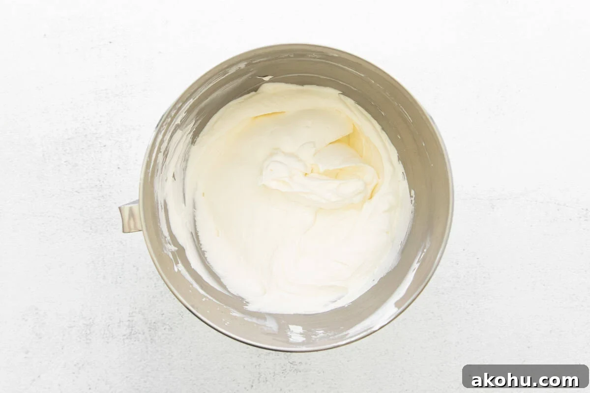 Whipped heavy cream in a silver bowl.