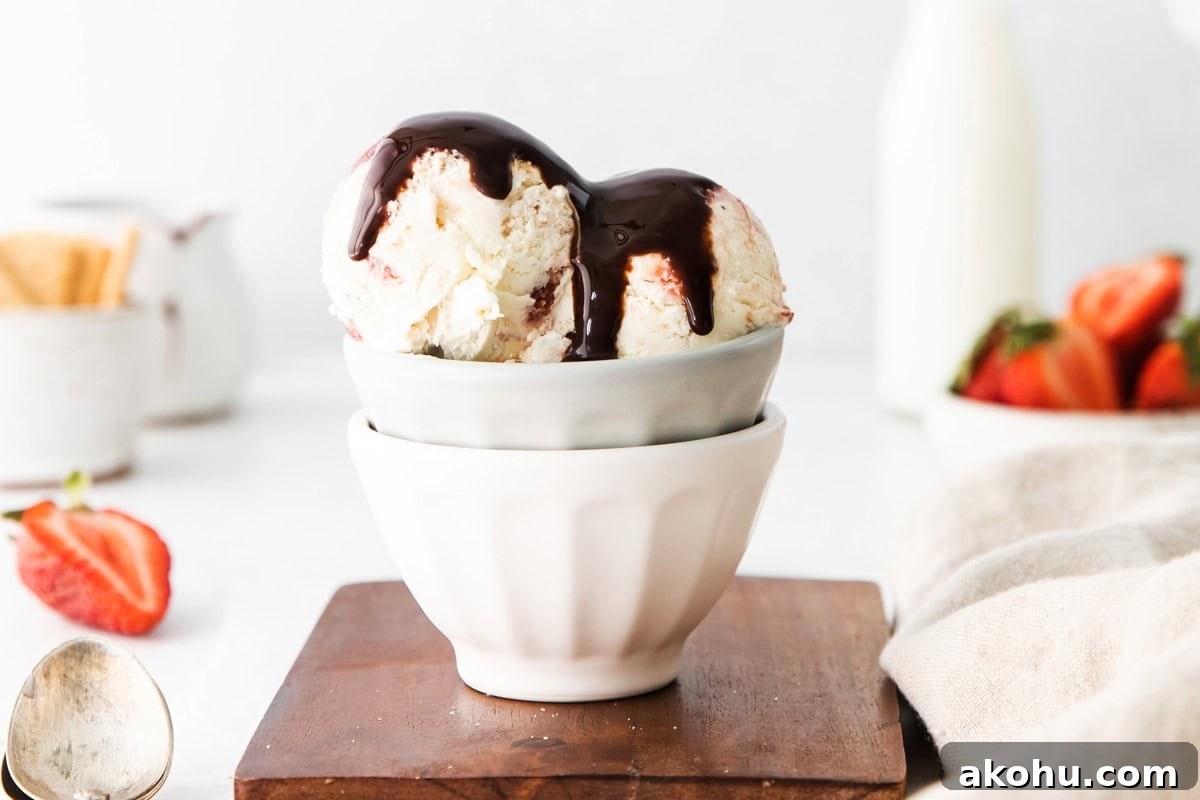 Ice cream with chocolate sauce on top served in a bowl.