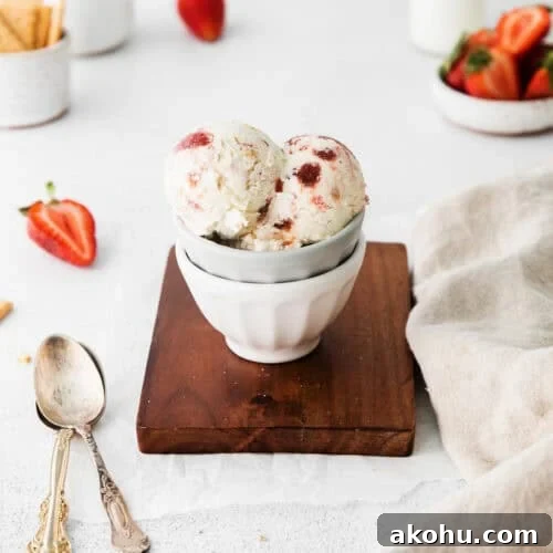 Scoops of strawberry cheesecake ice cream served in a small bowl.