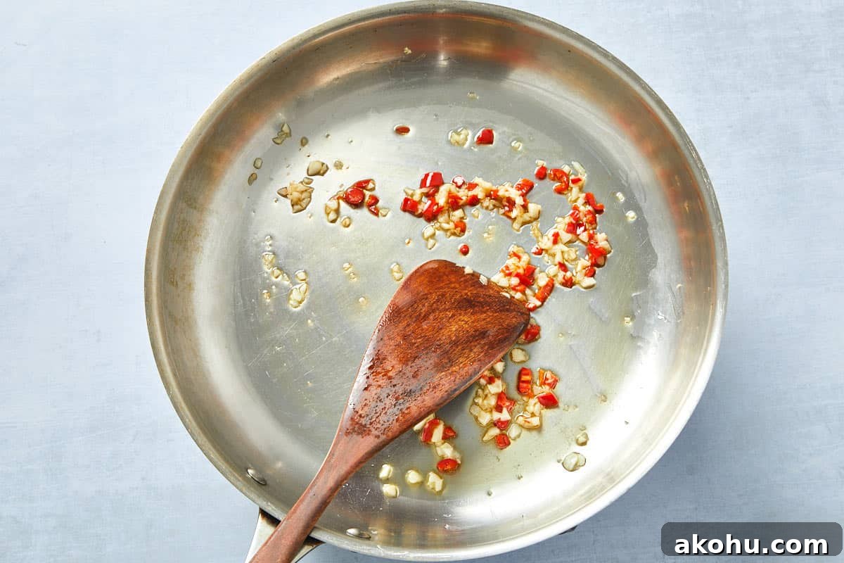 Finely chopped chili added to golden garlic, infusing heat into the creamy tomato pasta sauce.