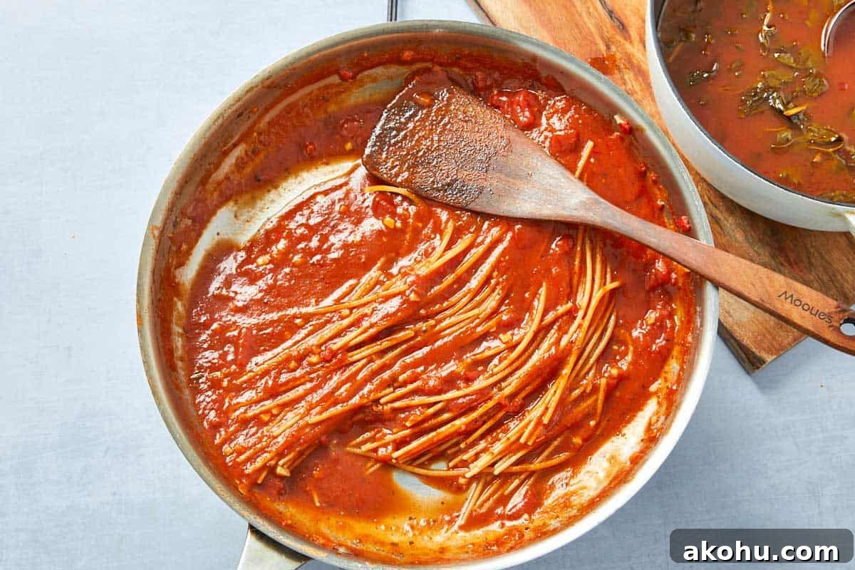 Cooked pasta coated in sauce, stirred until perfectly al dente with a rich tomato base.