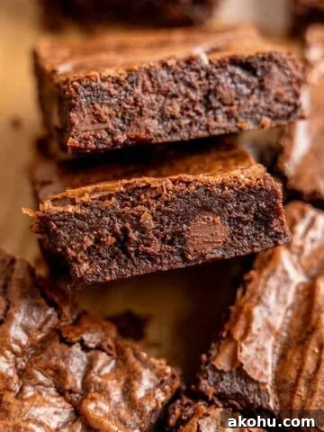 Slices of fudgy small batch brownies with chocolate chips and crinkly tops.