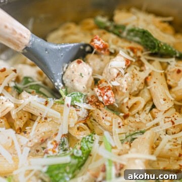 scooping a spoon of marry me chicken pasta.