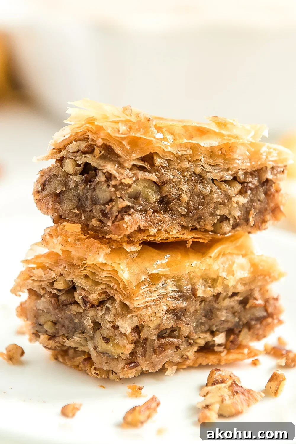 Authentic Homemade Baklava Recipe for Crispy Layers 2 Two pieces of Baklava stacked on top of each other.
