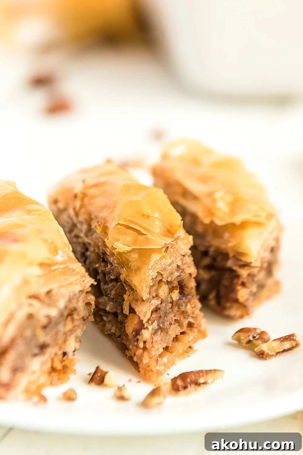 Authentic Homemade Baklava Recipe for Crispy Layers 3 Three pieces of baklava on a white plate.
