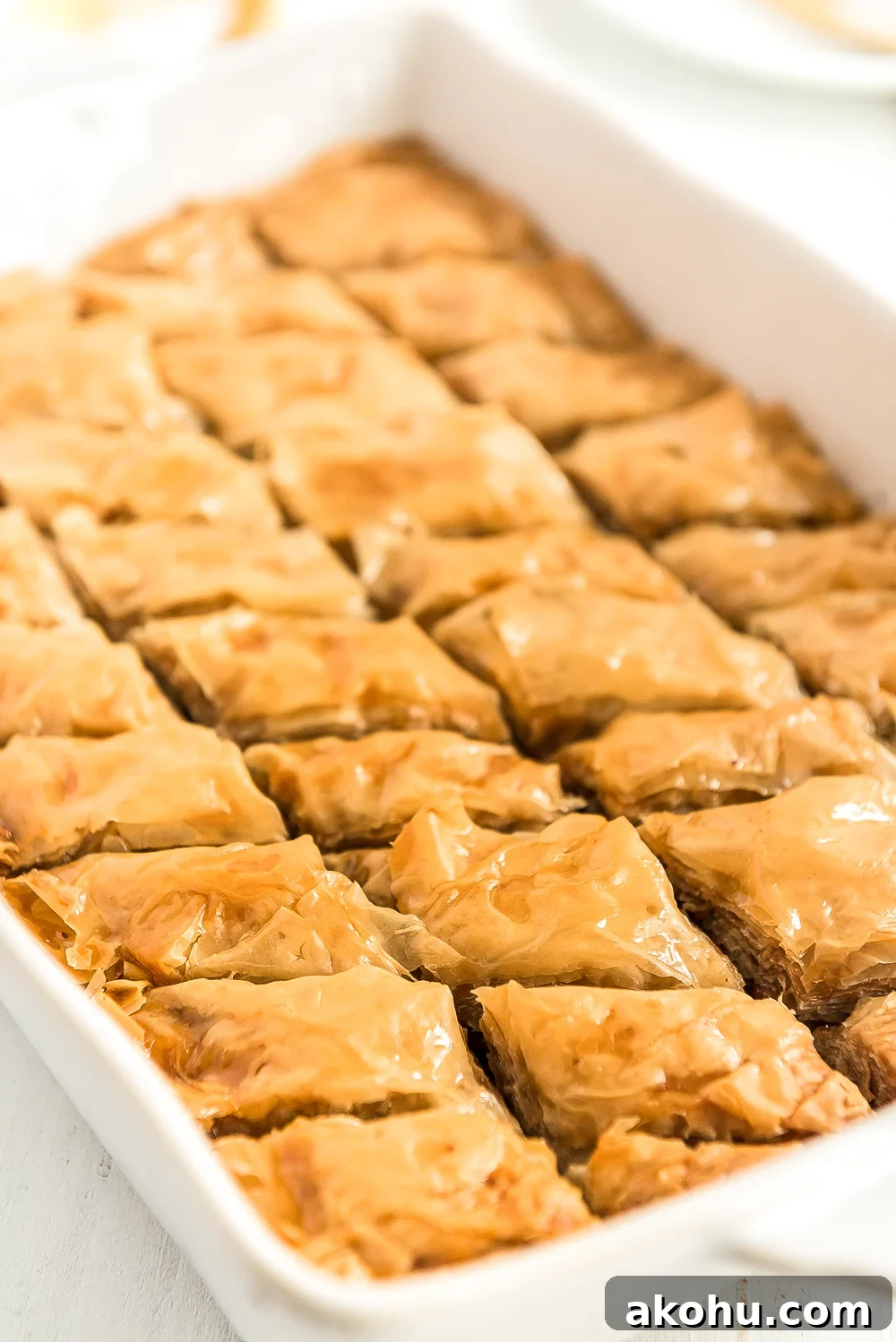 Authentic Homemade Baklava Recipe for Crispy Layers 5 Baked baklava in a white baking dish.