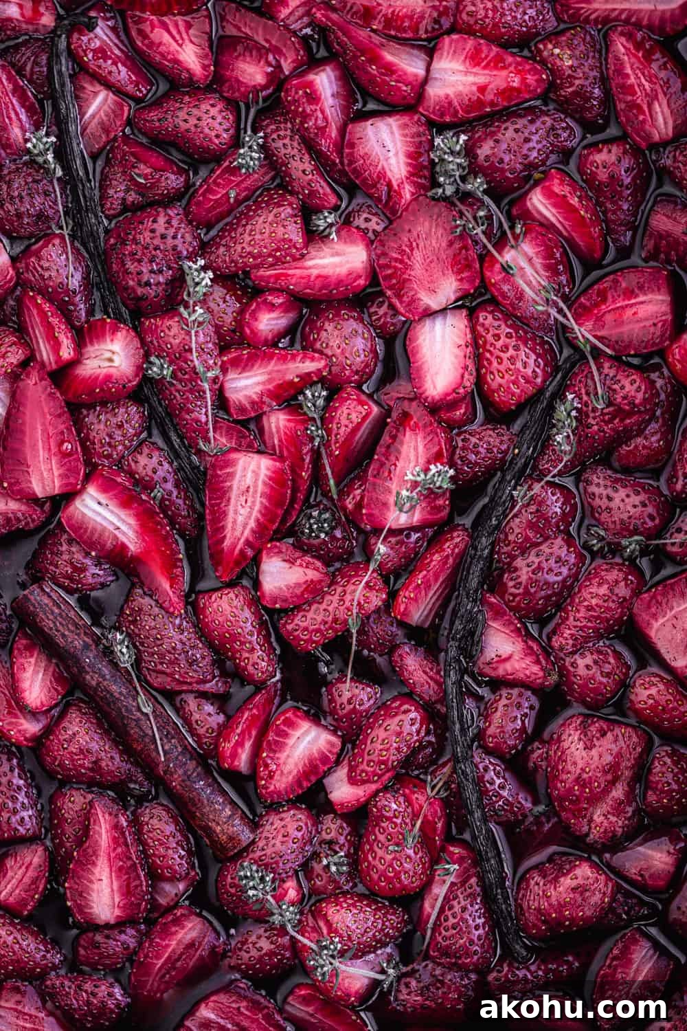roasted strawberries with vanilla, cinnamon and thyme on a baking sheet