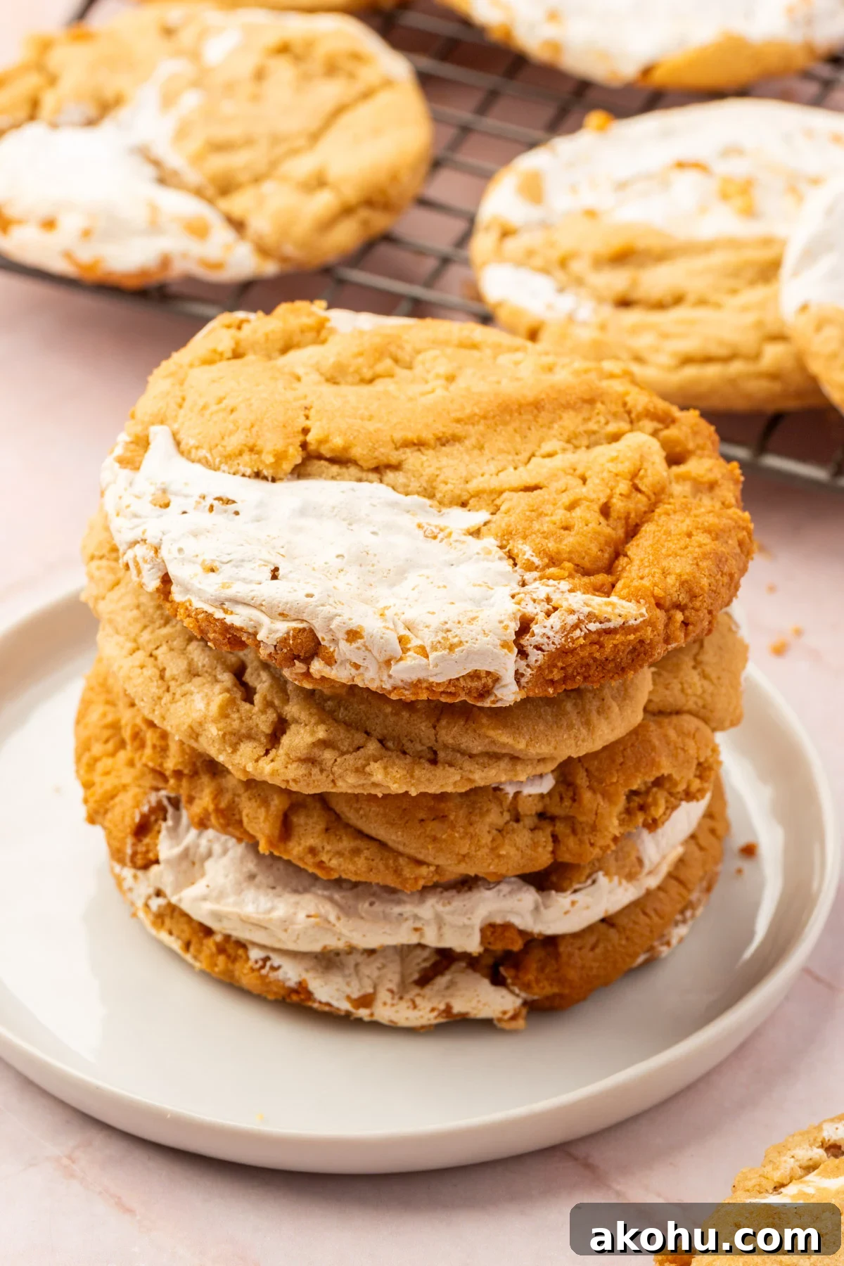 Image of gluten-free fluffernutter cookeis stacked on a white plate.