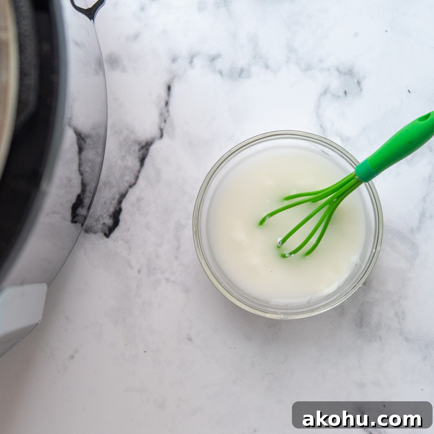 a cornstarch water slurry next to an open pressure cooker.