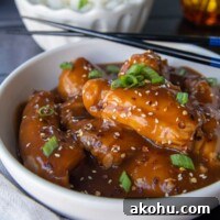 side angle shot of asian chicken thighs with chopsticks resting on side