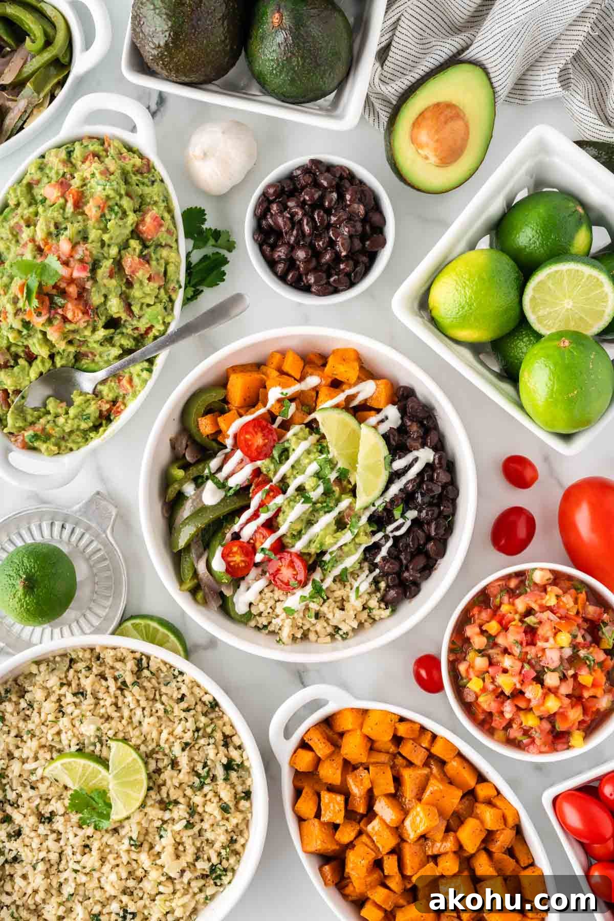 cauliflower rice burrito bowl with black beans, fajita veggies, sweet potatoes, and guacamole