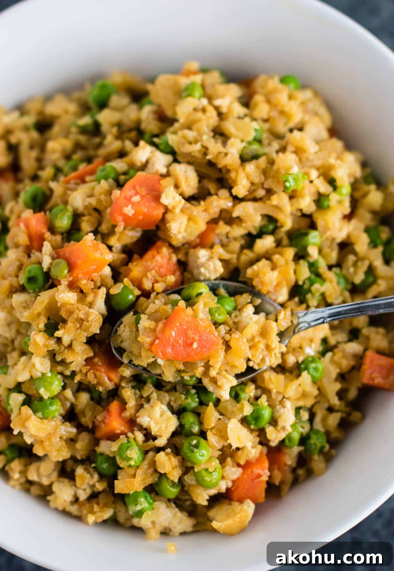 This cauliflower tofu fried rice is vegan, gluten free, grain free, and low carb. You won't believe this doesn't have rice or eggs in it! My new favorite dinner recipe! #grainfree #glutenfree #cauliflowerfriedrice #tofufriedrice #vegan #dinner #eggfree