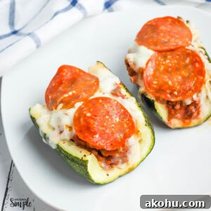 Pizza-Stuffed Zucchini Boats: Cheesy Italian-Style Recipe 2 2 Pizza Stuffed Zucchini Boats on white plate