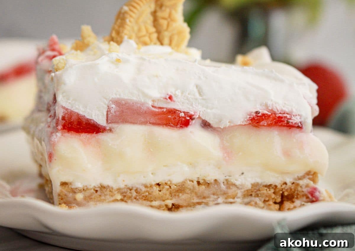Strawberry Cheesecake Lush Dessert Recipe — No-Bake Layered Treat 11 Slice of strawberry cheesecake lush on a plate.
