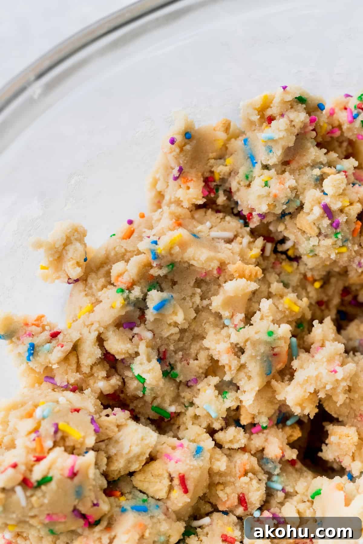 Close up of cookie dough in a glass bowl.