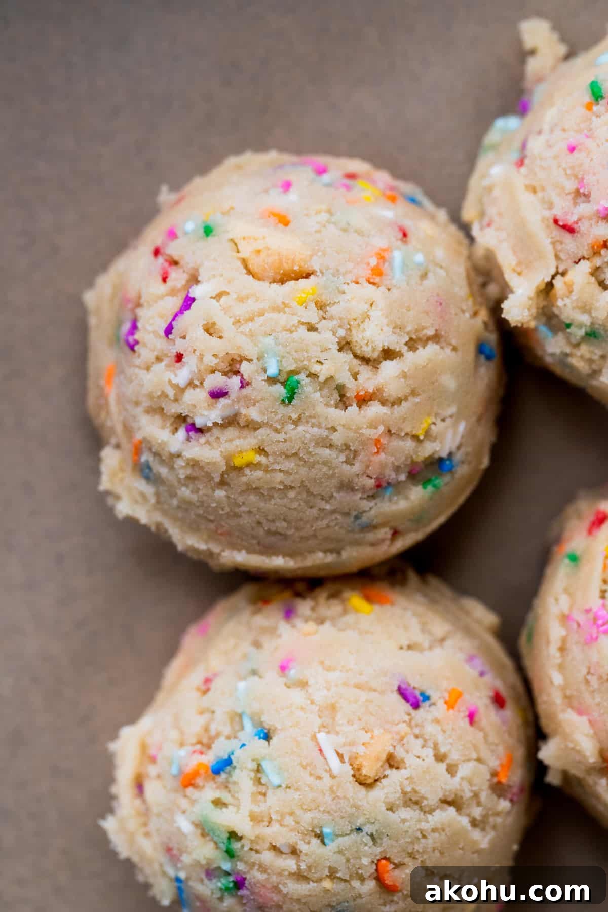 Cookie dough balls on parchment paper.