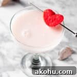 A white chocolate raspberry martini garnished with a heart shaped marshmallow.