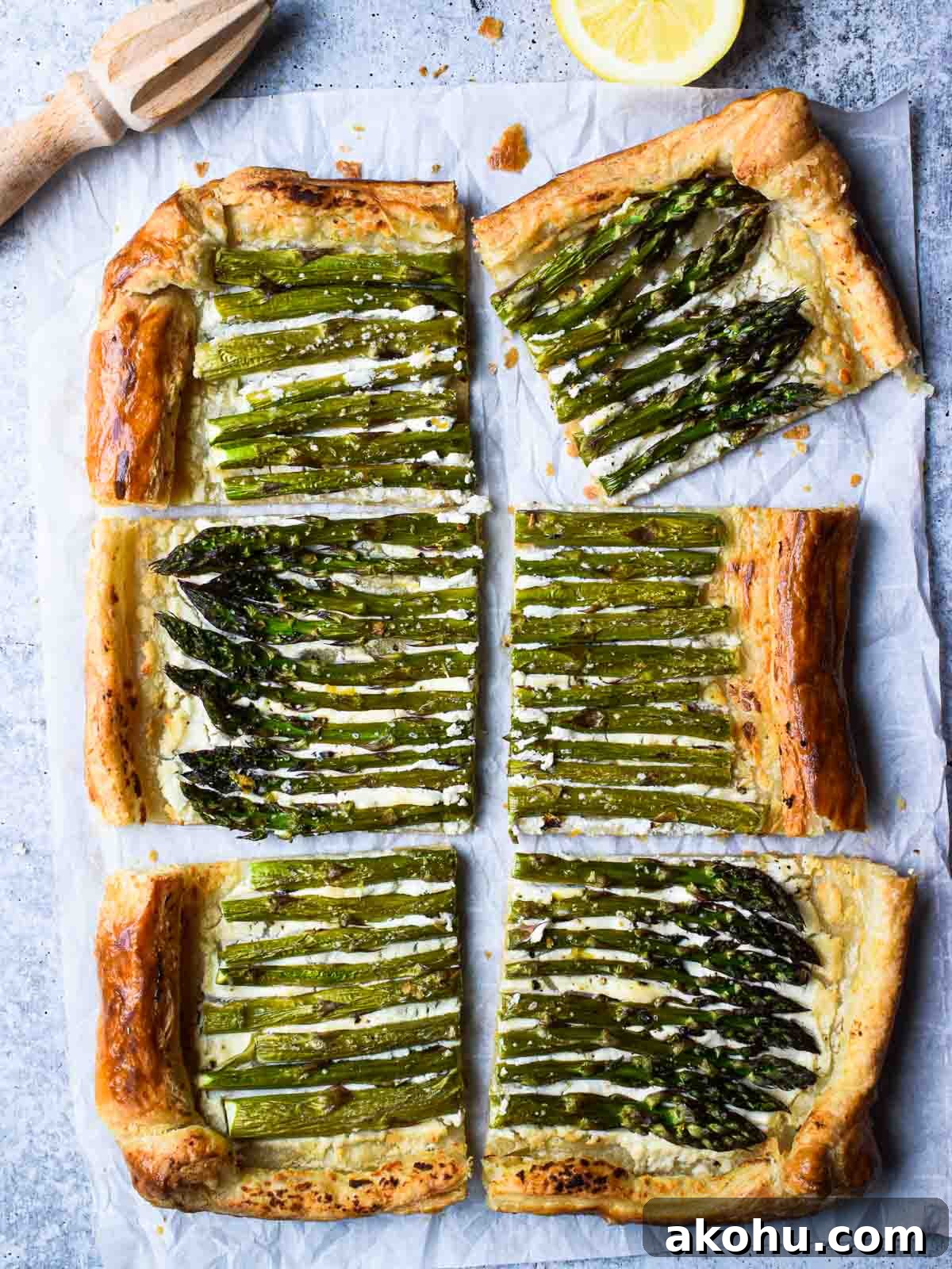 Asparagus and Whipped Goat Cheese Puff Pastry Tart 2 Overhead of asparagus and whipped goat cheese puff pastry tart cut into six pieces with a lemon to the side
