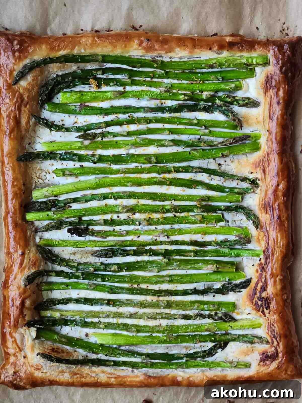 Asparagus and Whipped Goat Cheese Puff Pastry Tart 4 Overhead view of asparagus puff pastry with goat cheese.