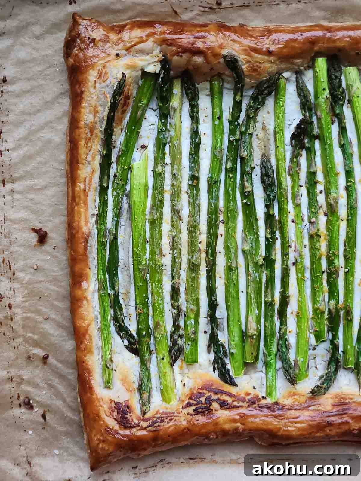 Asparagus and Whipped Goat Cheese Puff Pastry Tart 5 Asparagus and goat cheese puff pastry on parchment paper.