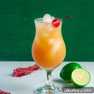 Refreshing Bacardi Rum Punch Recipe for Parties 7 a cocktail glass with Bacardi Rum Punch and a cherry for garnish