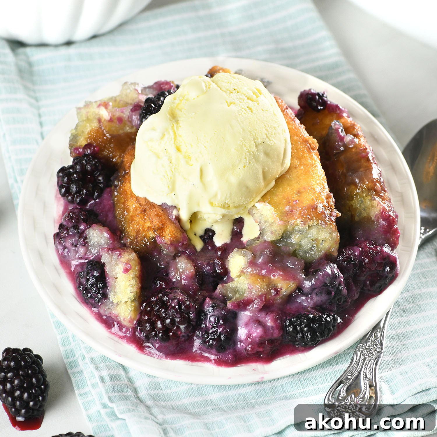 Easy blackberry cobbler served warm with juicy blackberries, golden buttery topping, and a scoop of vanilla ice cream.